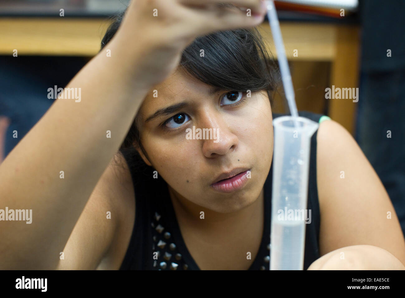 Female Hispanic student in science lab at Achieve Early College High School in McAllen, TX on the campus of South Texas College. Stock Photo