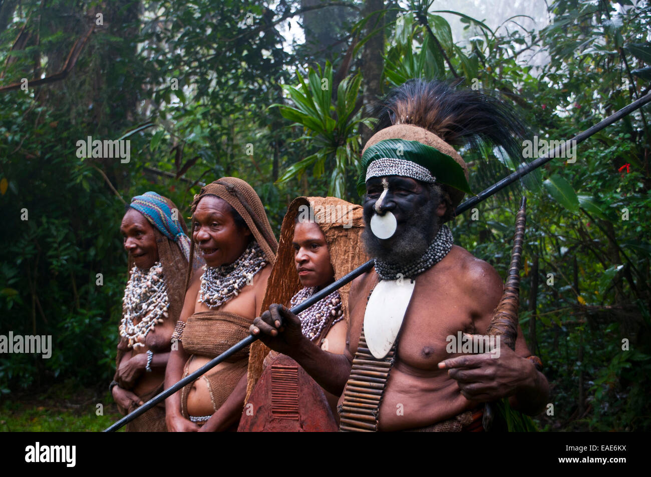 Tribal chief and three women wearing traditional dresses, Highlands Region, Papua New Guinea Stock Photo