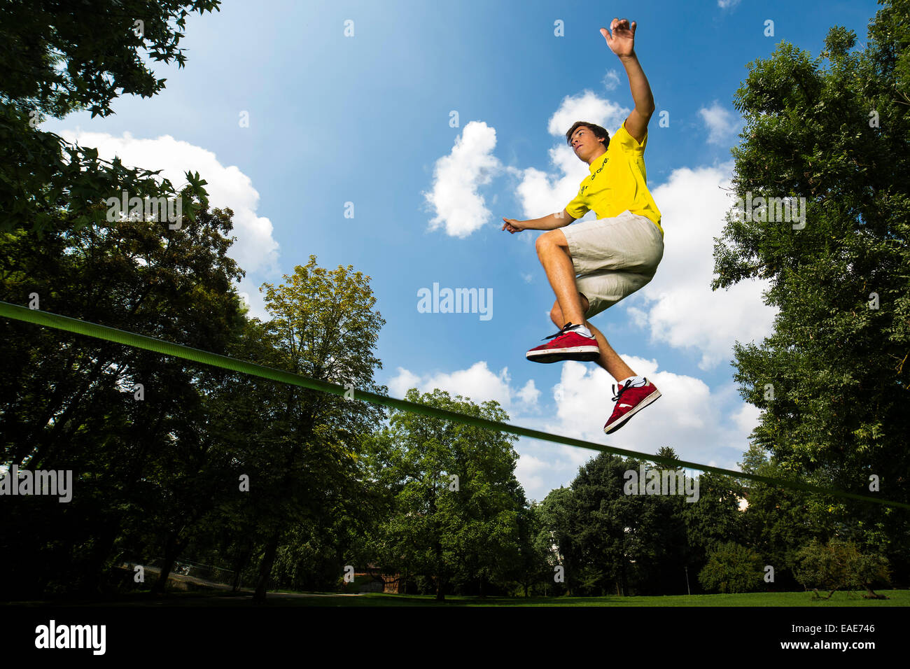 Athlete jumping on a slackline, Waiblingen, BadenWürttemberg, Germany