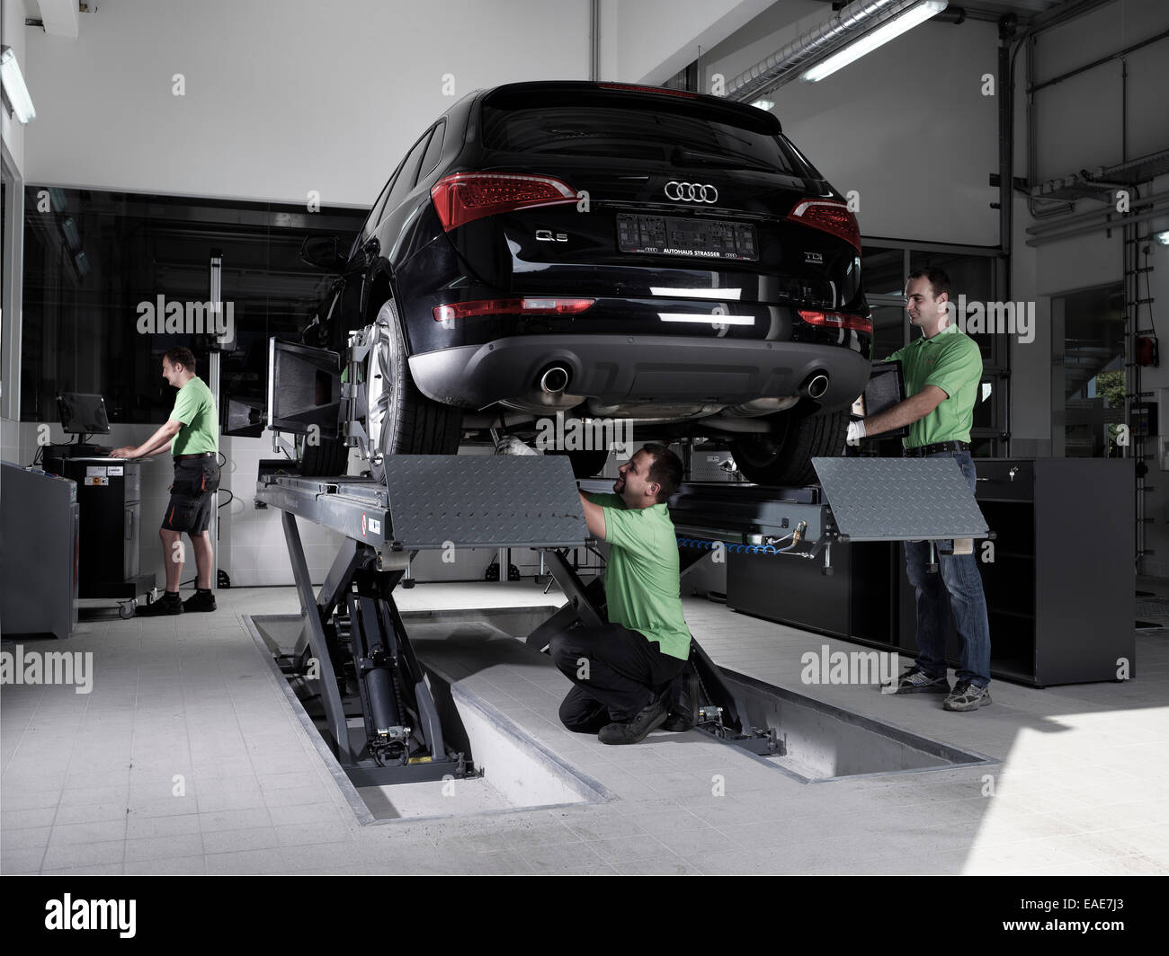 Workers assembling panels to track wheel alignments, VW Strasser