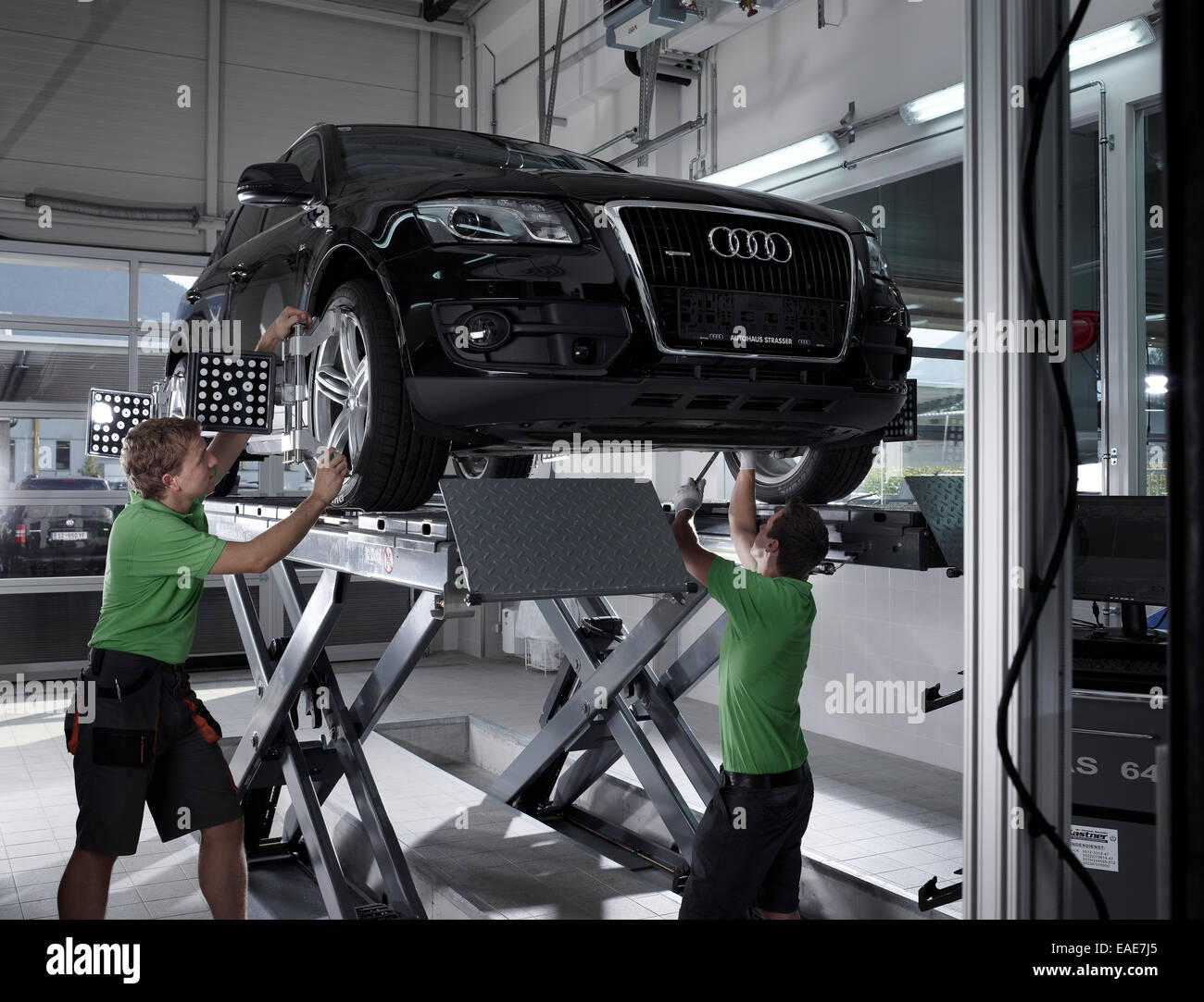 Workers assembling panels to track wheel alignments, VW Strasser