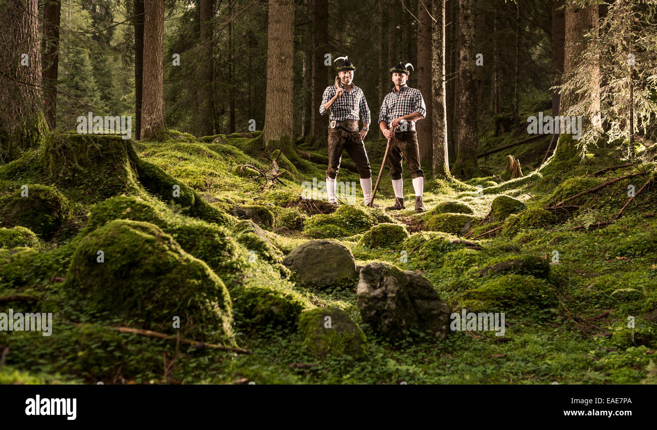 Woodcutters standing in a forest, Alpbach, Tyrol, Austria Stock Photo