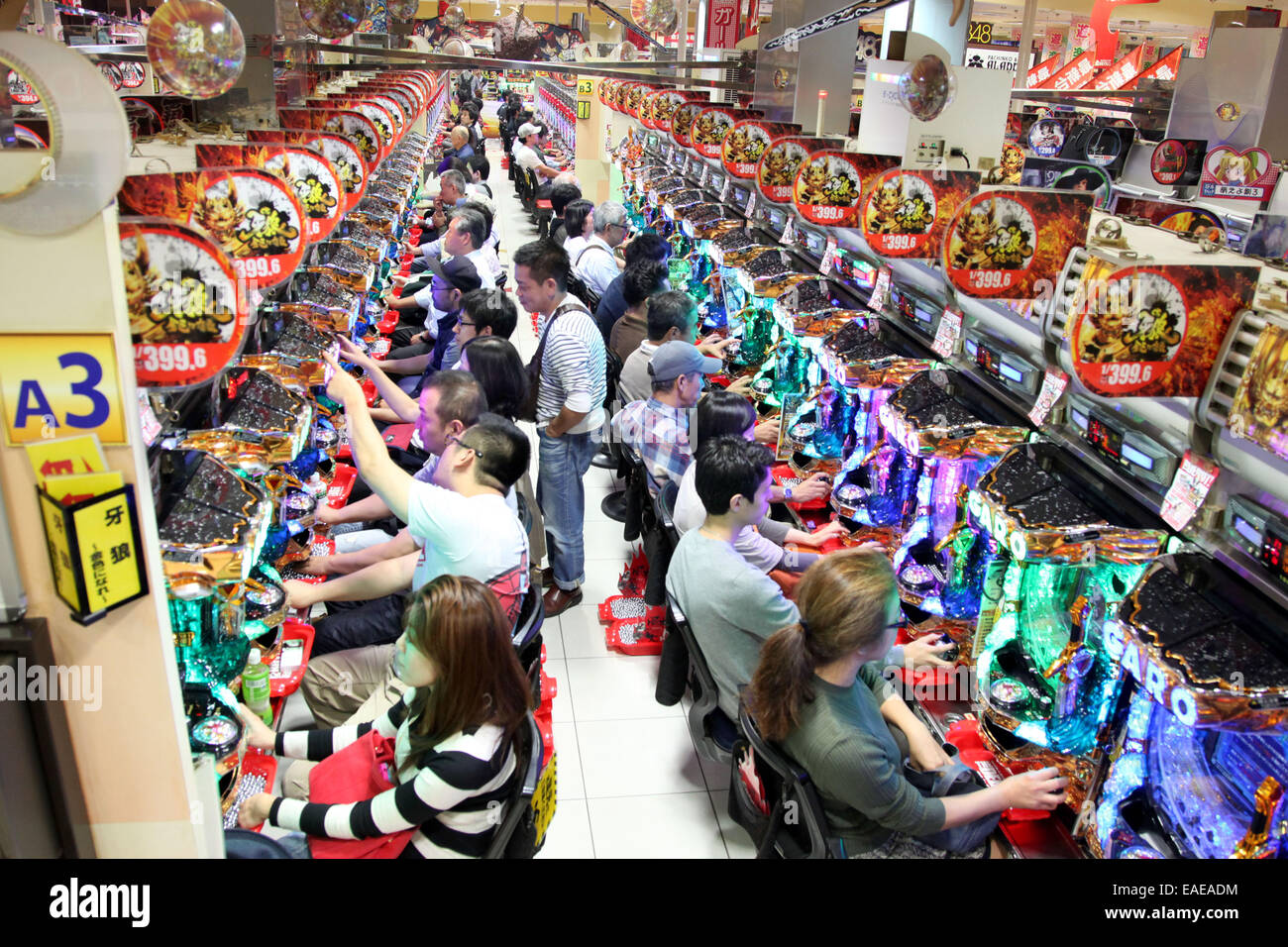 Guests pictured in a pachinko arcade in Tokyo, September 28, 2014. Pachinko is a typical Japanese slot game. Photo: Friso Gentsch/dpa Stock Photo