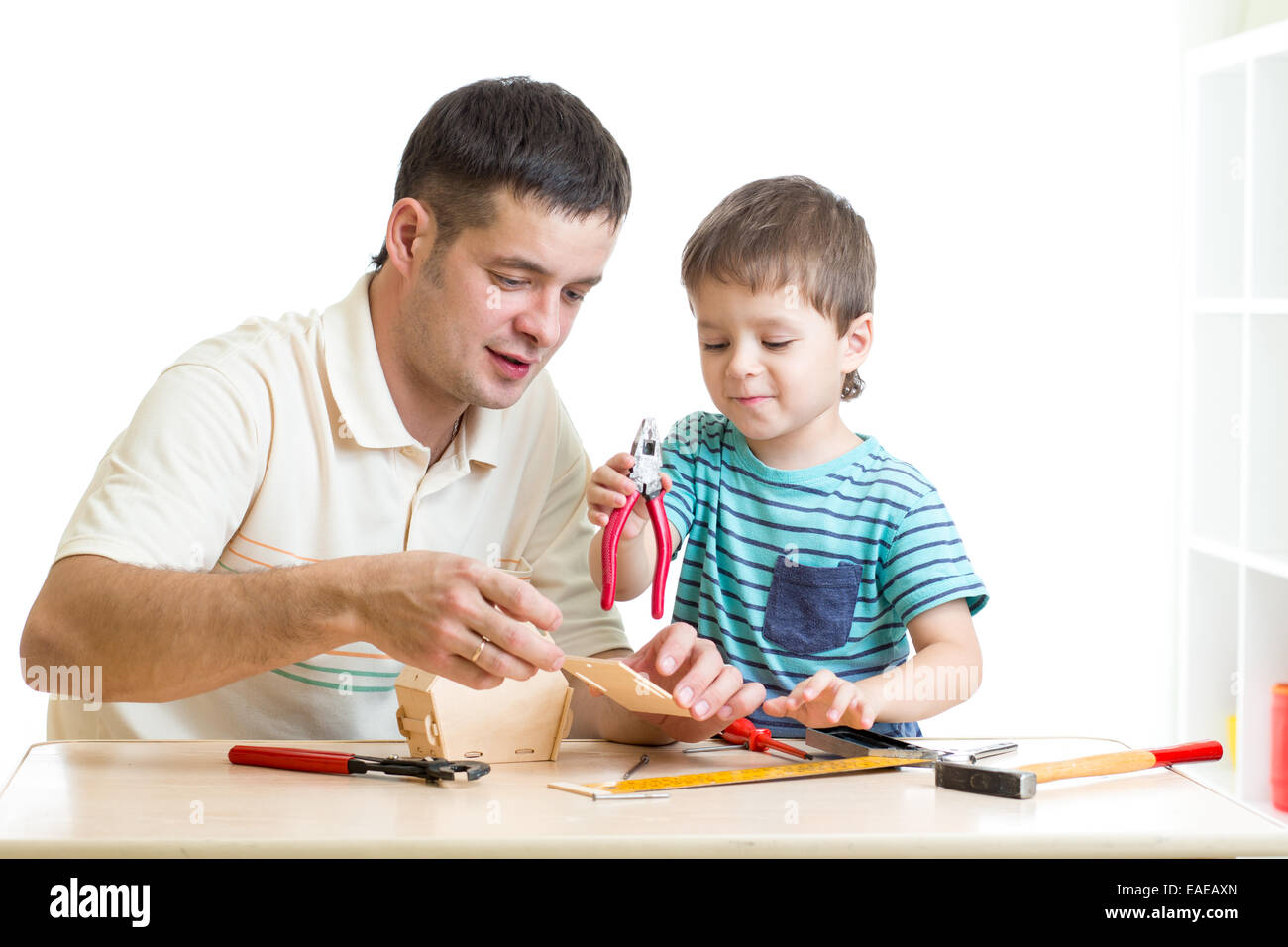 Dad and son child working with tools together Stock Photo