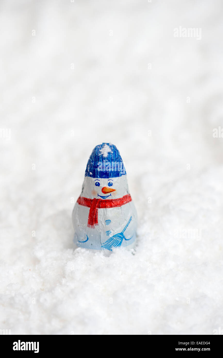 Christmas tree snowman decoration chocolates in snow Stock Photo