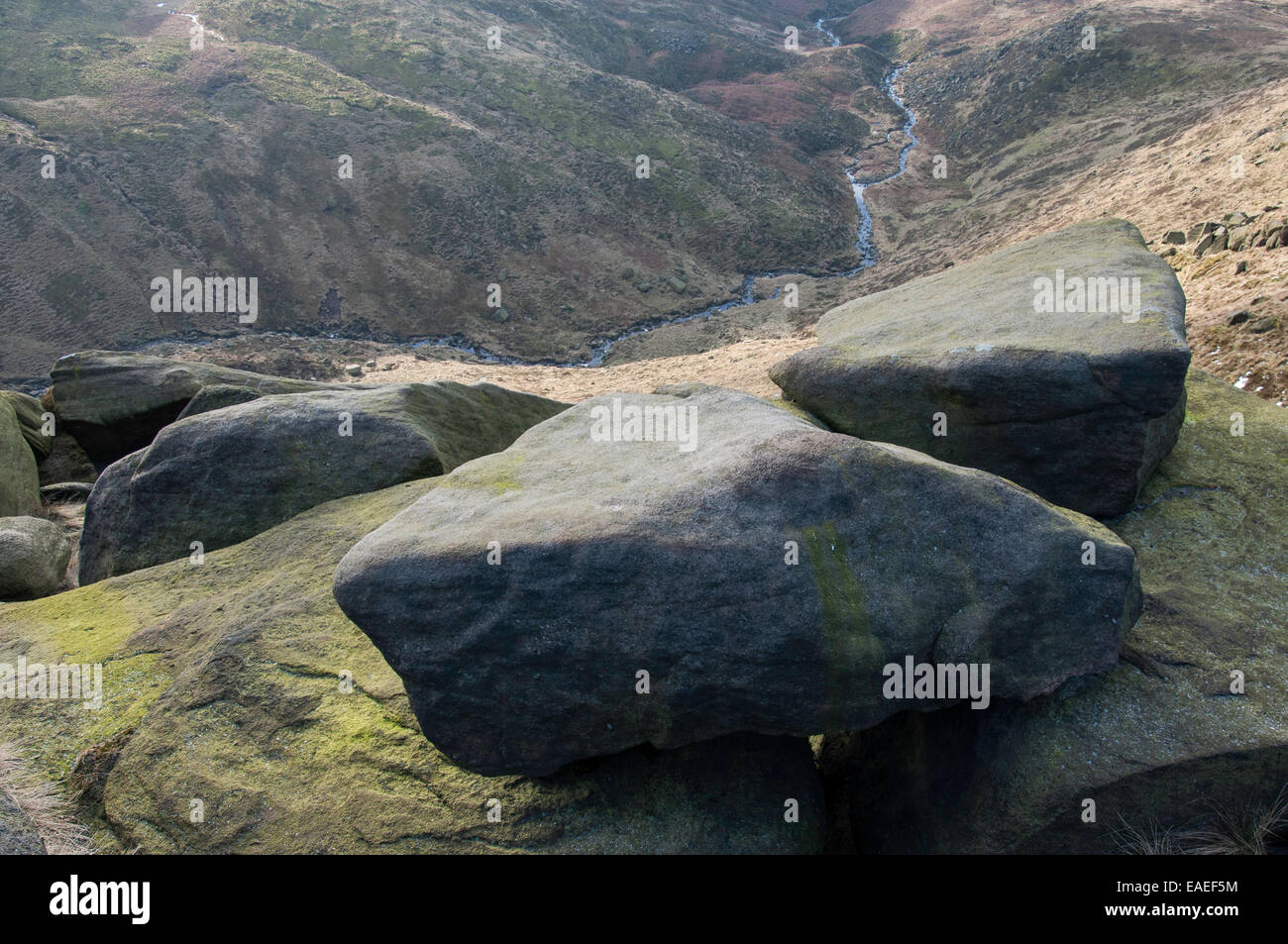 Gritstone rocks on edge of the Kinder Scout plateau. View looking down into the valley far below. Peak District, Derbyshire, UK. Stock Photo