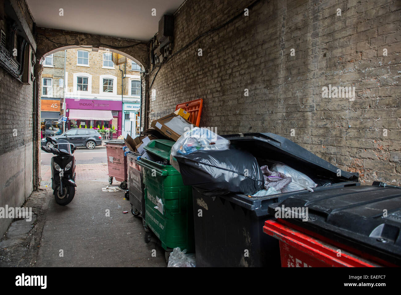 London, UK. 13th November, 2014. An alleyway has just sold at auction £260,000 ( nearly 5x the guide price of £55k) via Savilles.  The site has been sold with planning permission for a residential home. It is wedged between a Starbucks and Trinity Hospice,  charity shop on Northcote Road, Clapham London SW4 - the area is known as Nappy Valley becaus of all teh family homes. Credit:  Guy Bell/Alamy Live News Stock Photo