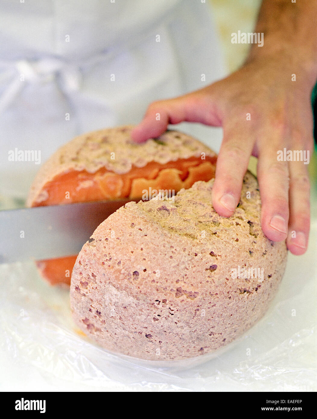 Opening a Mimolette Cheese Stock Photo