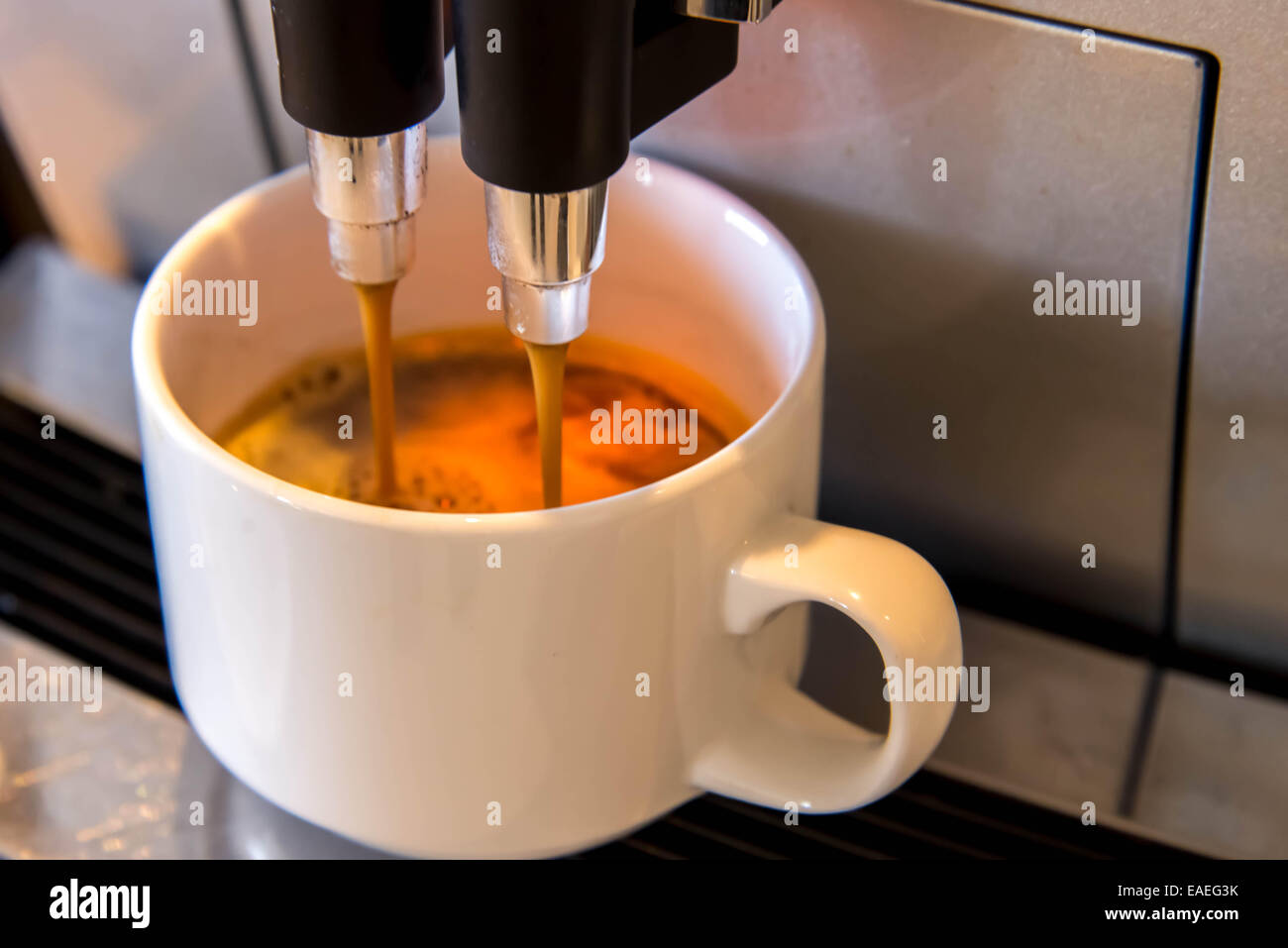 espresso dripping form the coffee machine Stock Photo Alamy