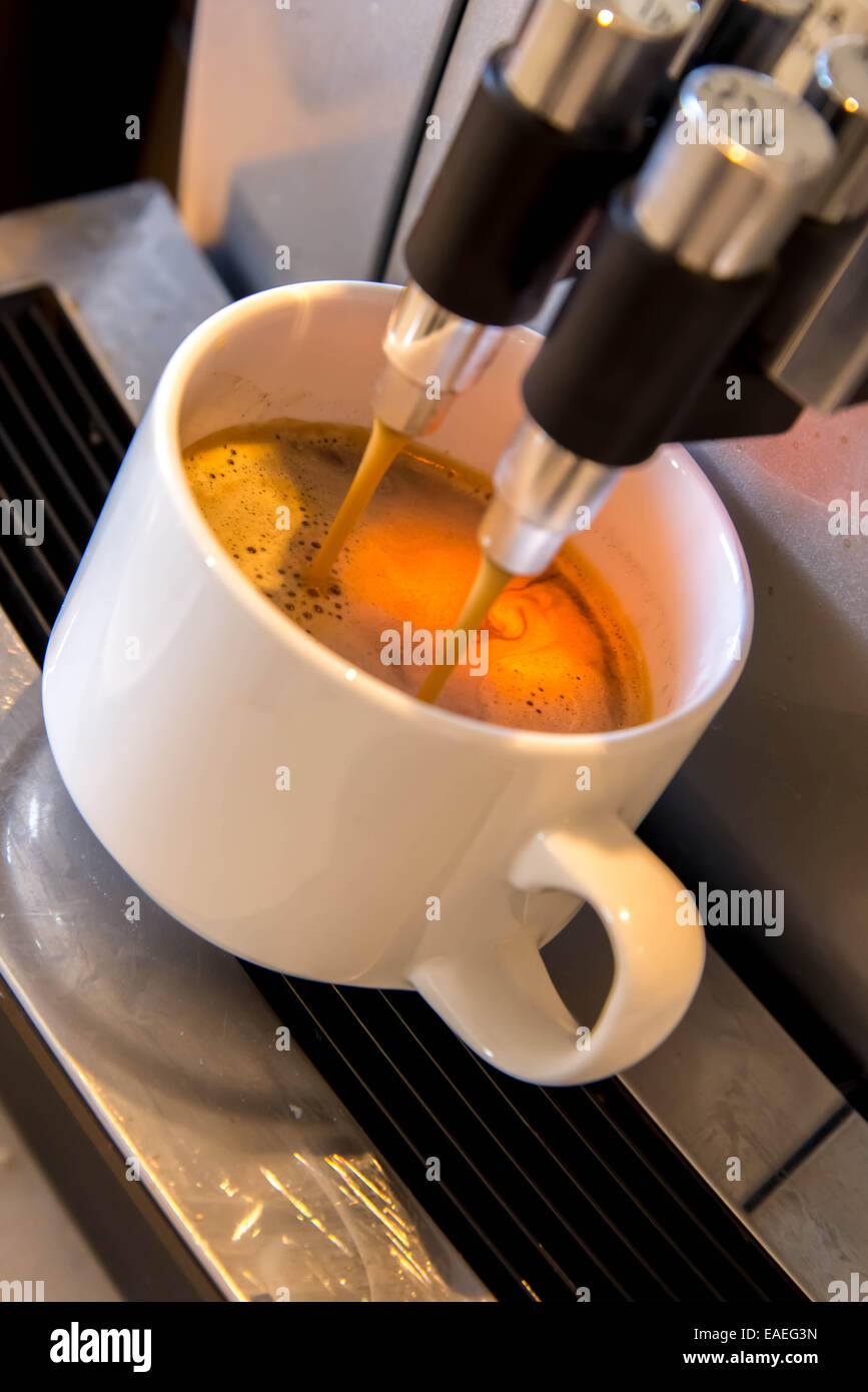 espresso dripping form the coffee machine Stock Photo Alamy