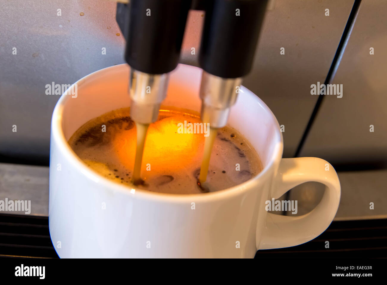 espresso dripping form the coffee machine Stock Photo Alamy