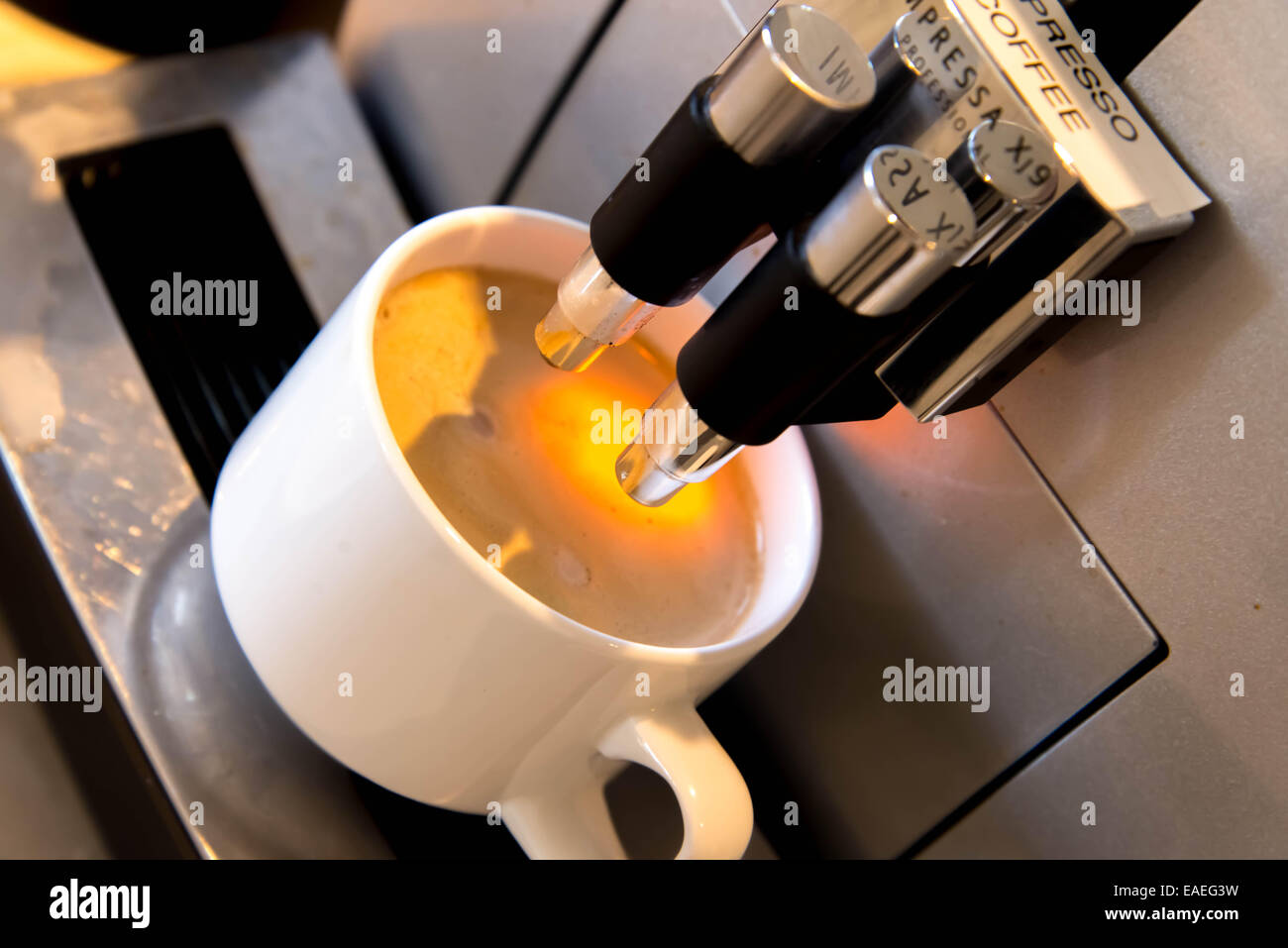 espresso dripping form the coffee machine Stock Photo Alamy