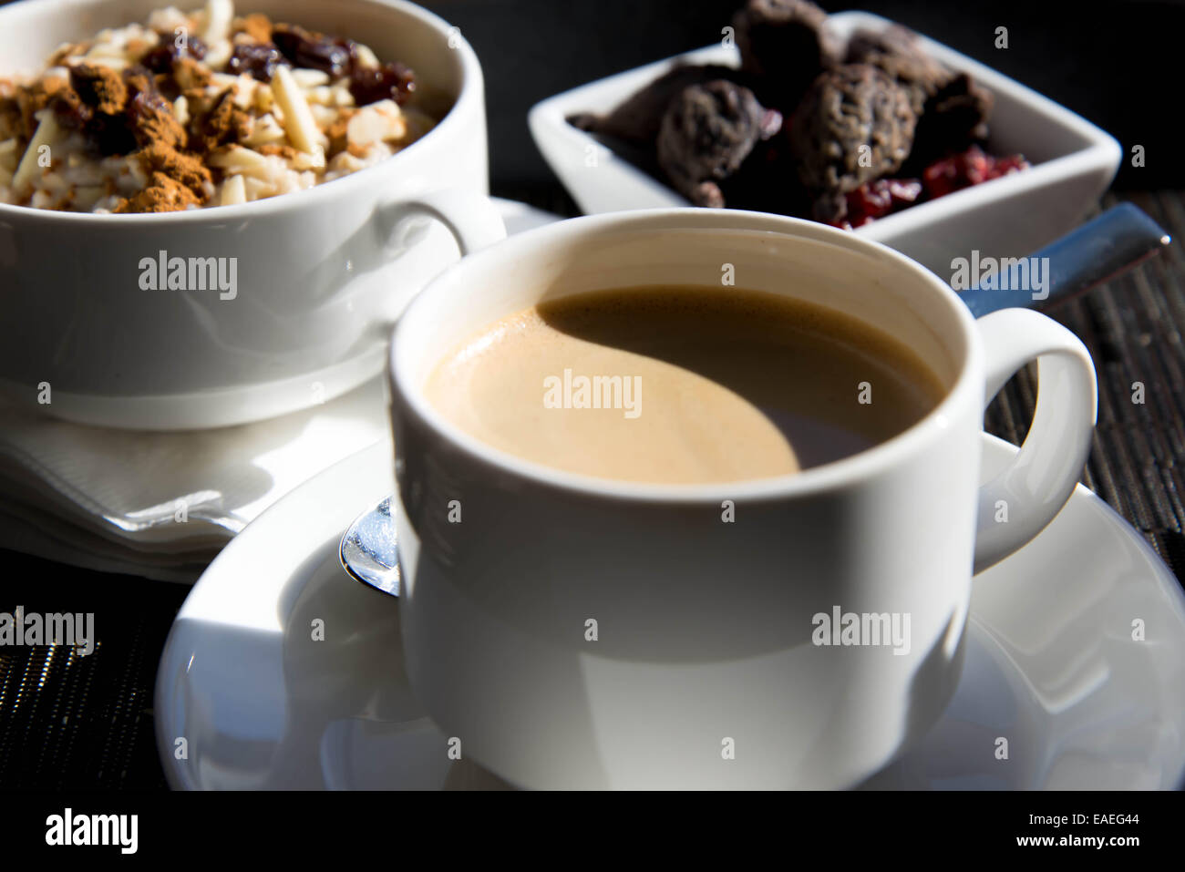coffee and oatmeal with dried fruit nutritious breakfast setting Stock