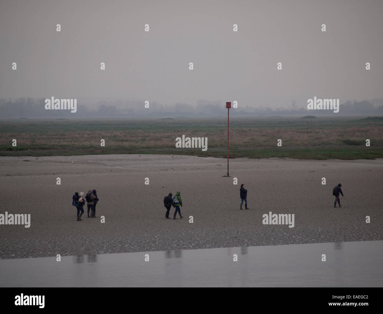 Walkers on the mudflats of the bay of the Somme, close to Saint-Valery-sur-Somme Stock Photo