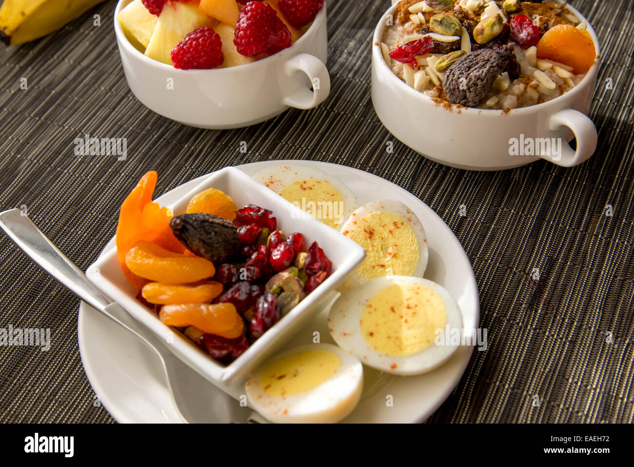 Fresh fruit and oatmeal with nuts and fruit toppings for breakfast Stock Photo