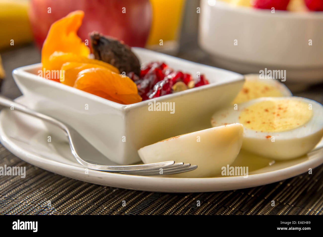 Sliced hard boiled eggs and fruit healthy breakfast Stock Photo