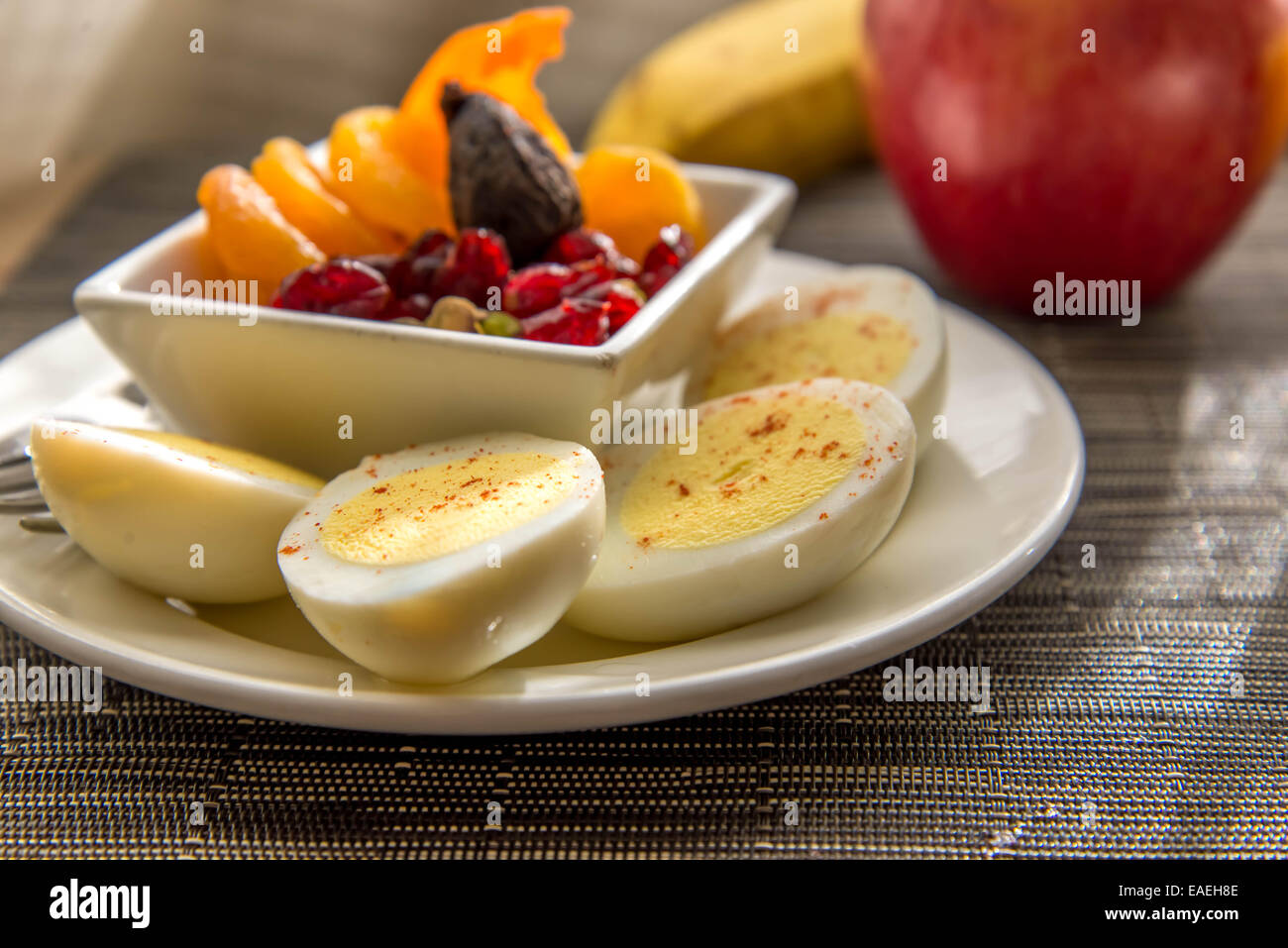 Sliced hard boiled eggs and fruit healthy breakfast Stock Photo