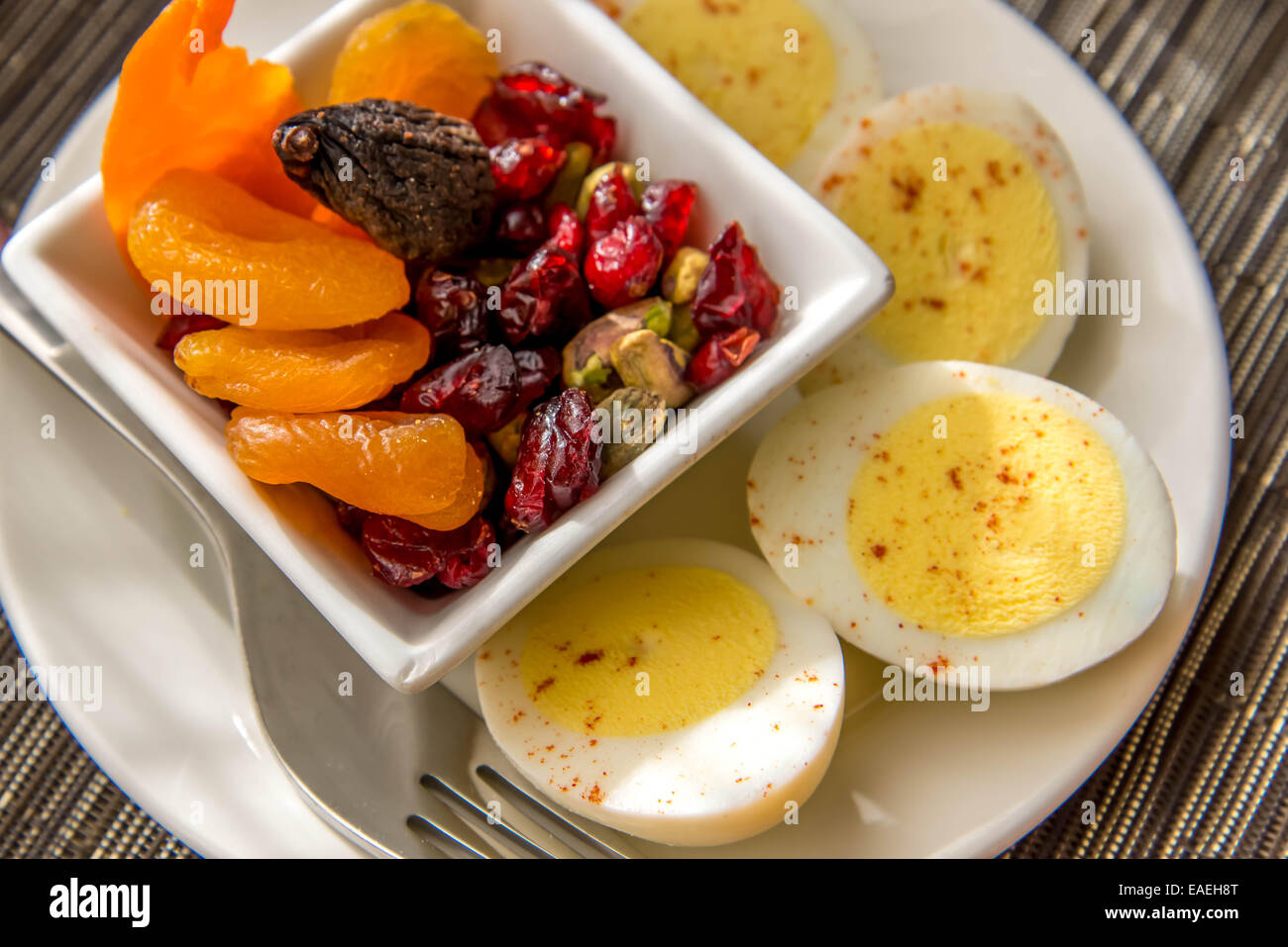 Sliced hard boiled eggs and fruit healthy breakfast Stock Photo