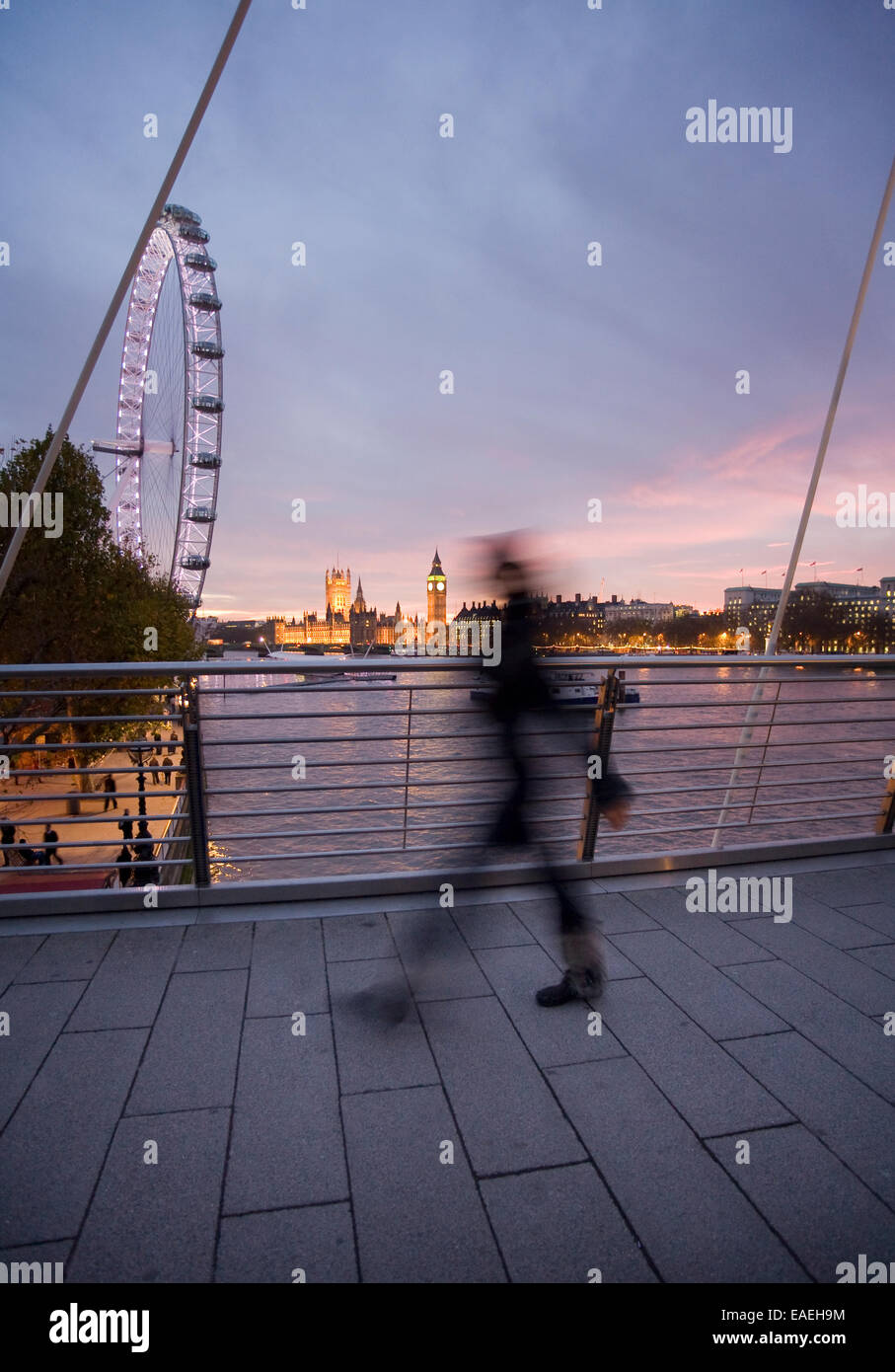 blurred unrecognisable person walking over Hungerford (Golden Jubilee) Bridge, London Stock Photo