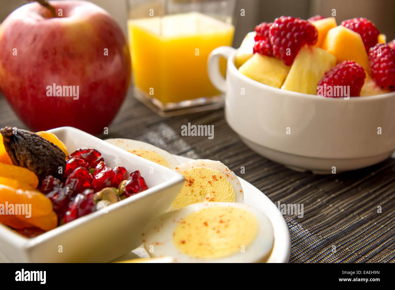 Sliced hard boiled eggs and fruit healthy breakfast Stock Photo