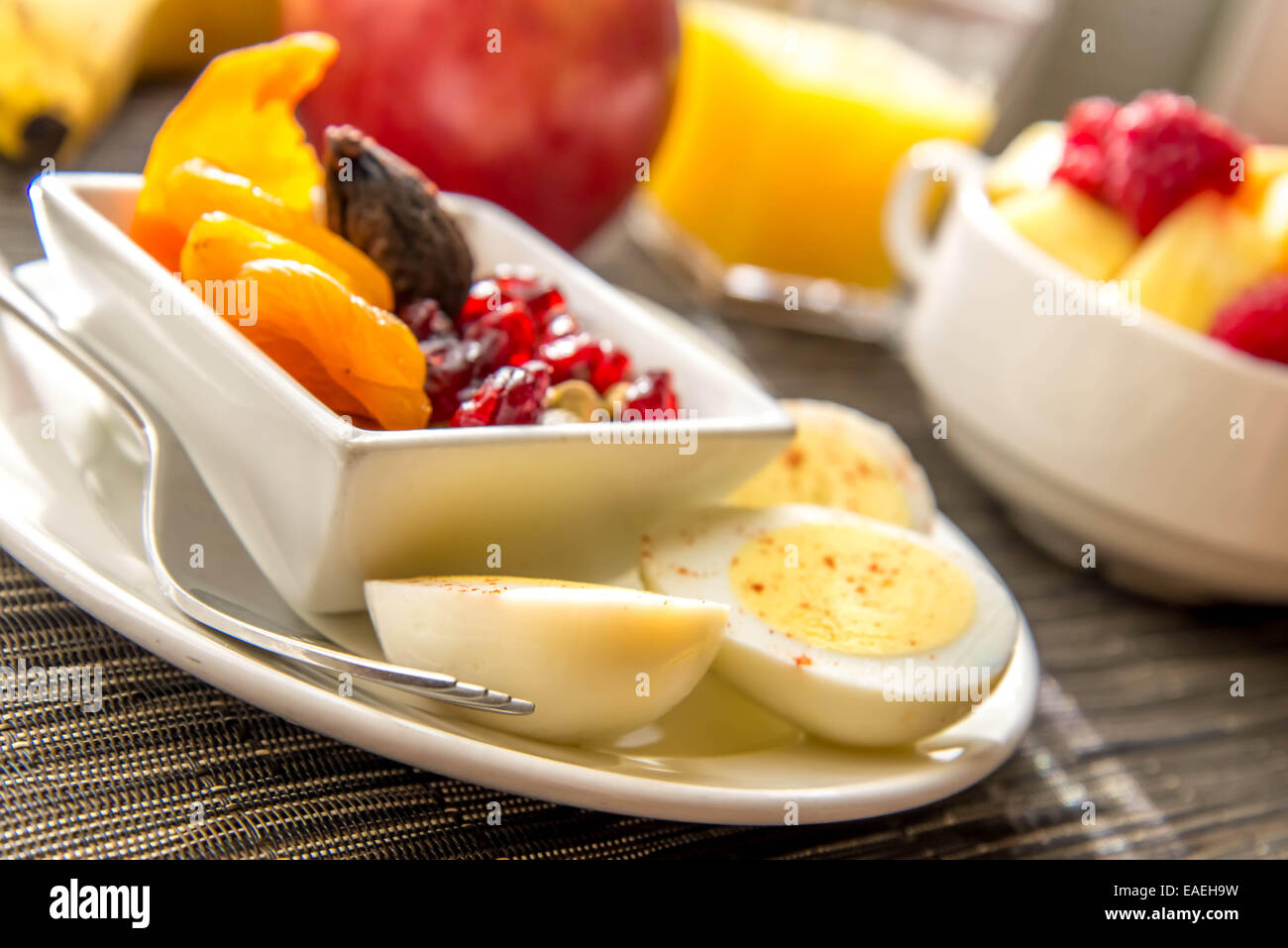 Sliced hard boiled eggs and fruit healthy breakfast Stock Photo