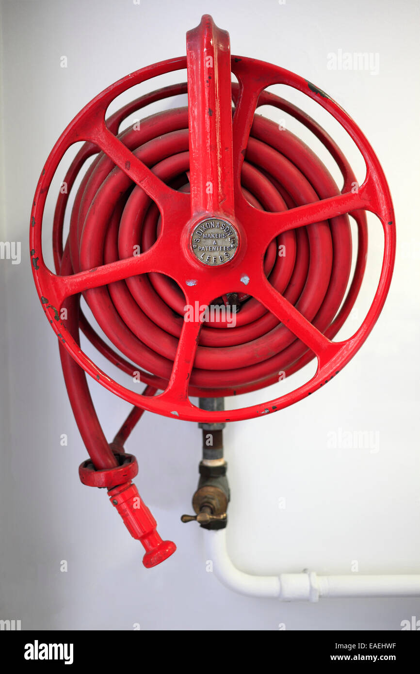 Red fire hose reel. Stock Photo