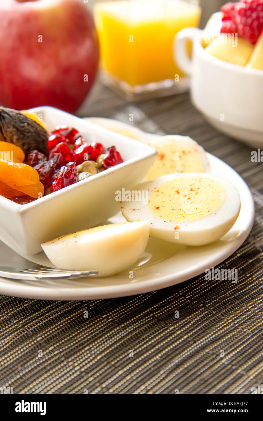 Sliced hard boiled eggs and fruit healthy breakfast Stock Photo