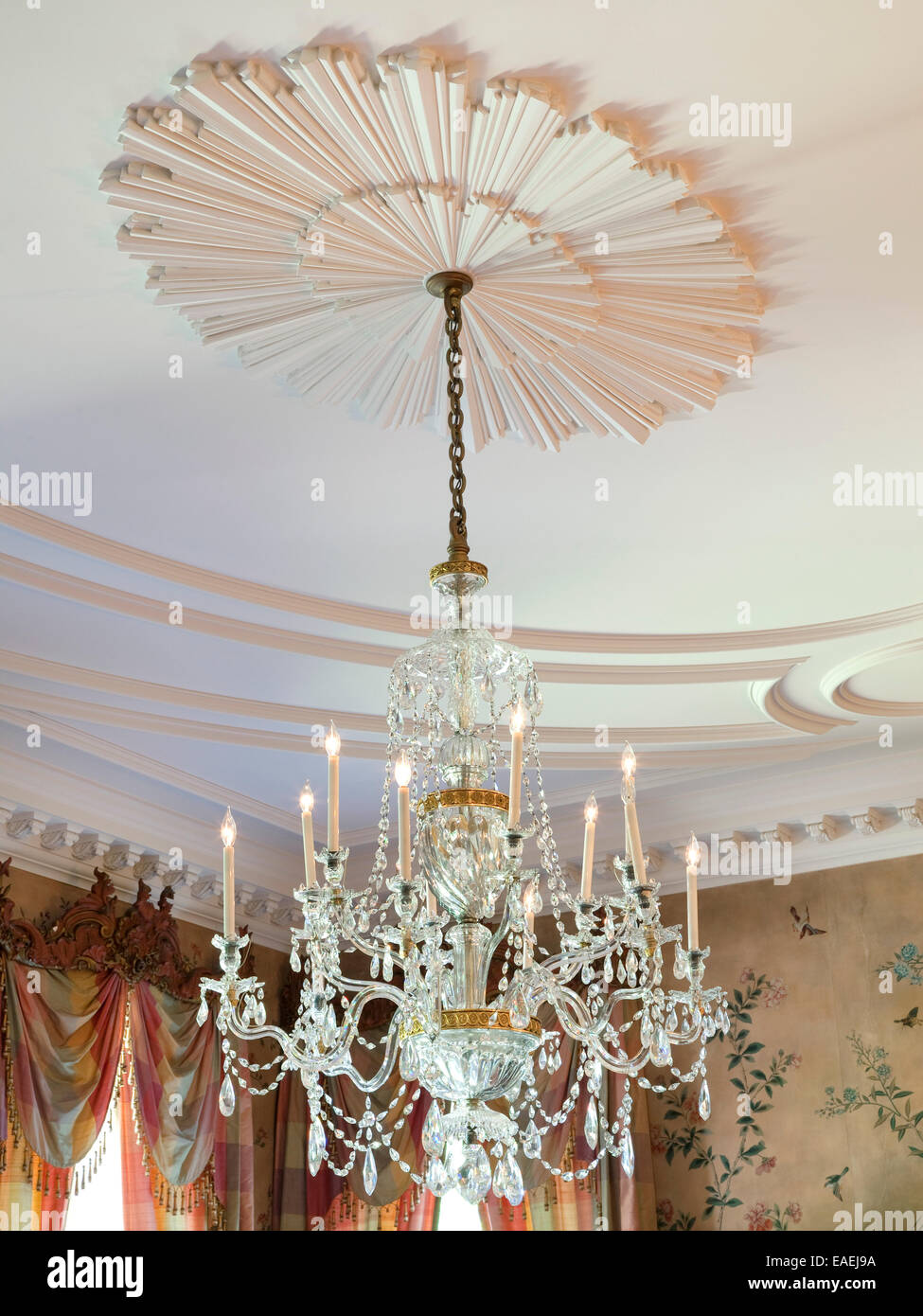 crystal chandelier and medallion on ceiling in dining room of Swan House. Stock Photo