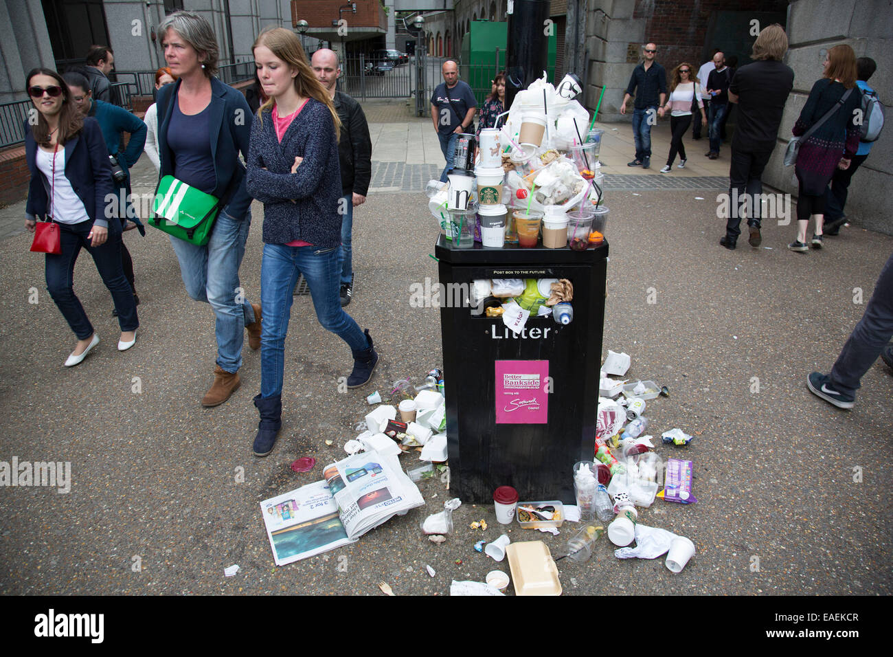 Overflowing bin and litter in London, UK. Increased number of people