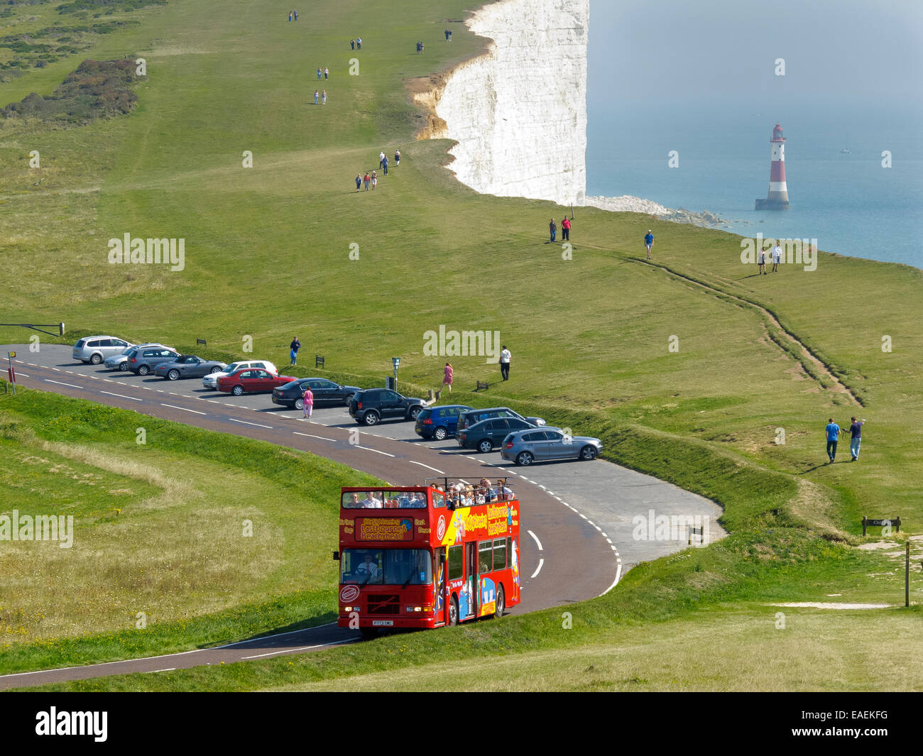 The White Cliffs and Beachy Head lighthouse with a Eastbourne City Sightseeing open top double decker tour bus Stock Photo