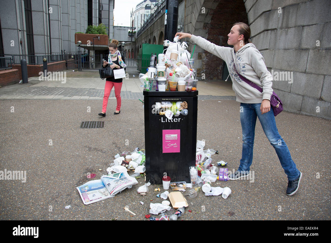 Overflowing bin and litter in London, UK. Increased number of people