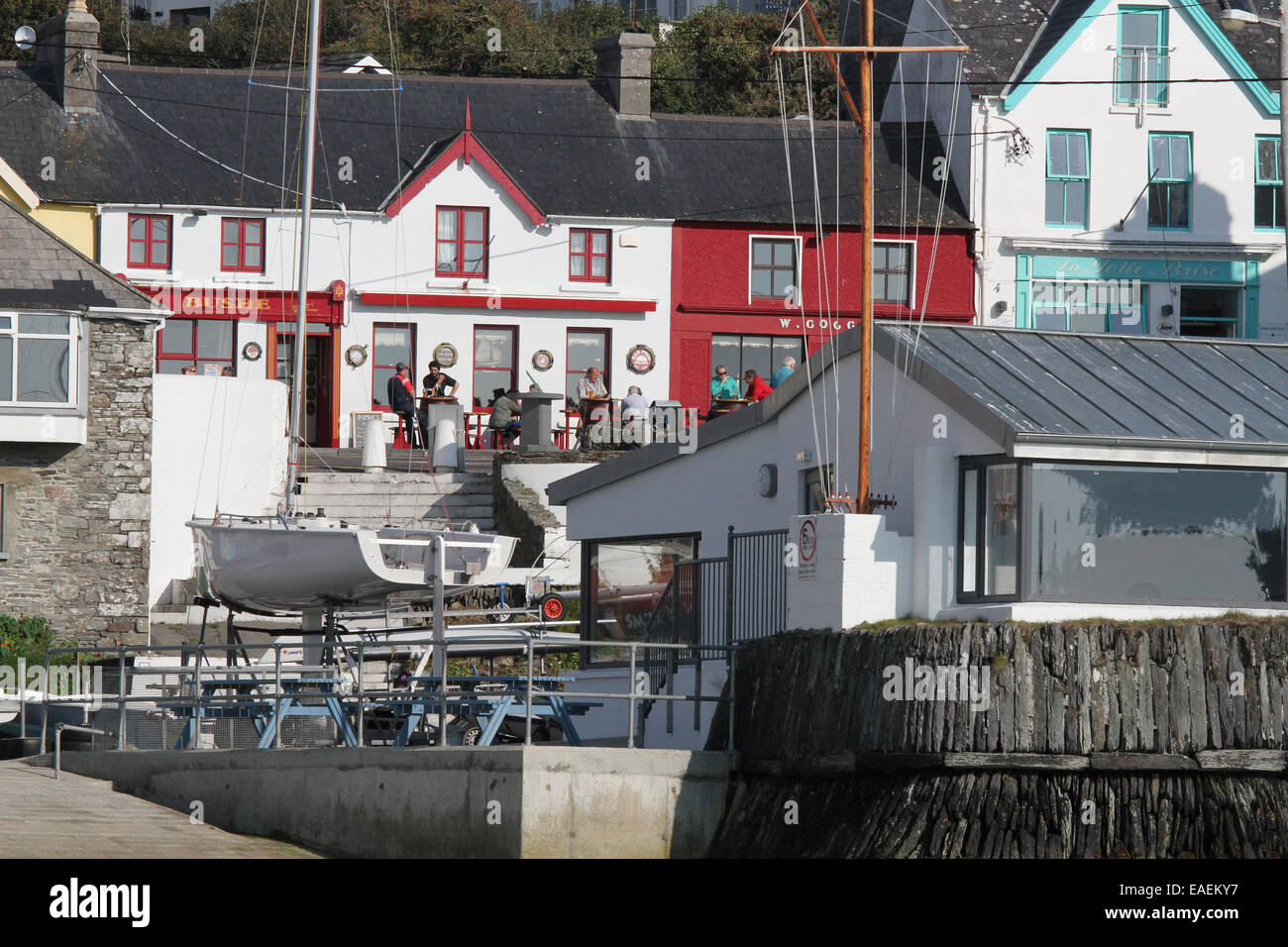 People outside a pub in Ireland at the waterfront above the harbour at Baltimore West Cork