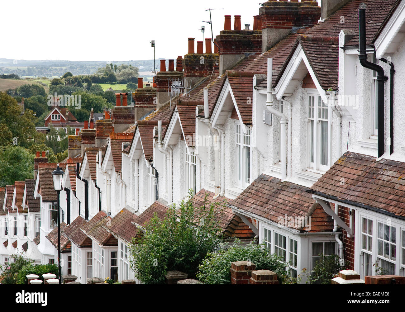 A hilly street of attractive but generic terraced homes in Lewes, Sussex, England Stock Photo