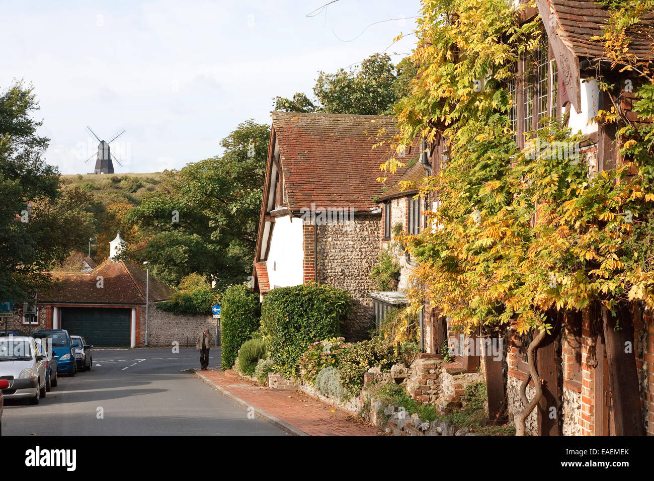 Rottingdean village - its old buildings and windmill, East Sussex. The man in the image happens to have his face covered and is Stock Photo