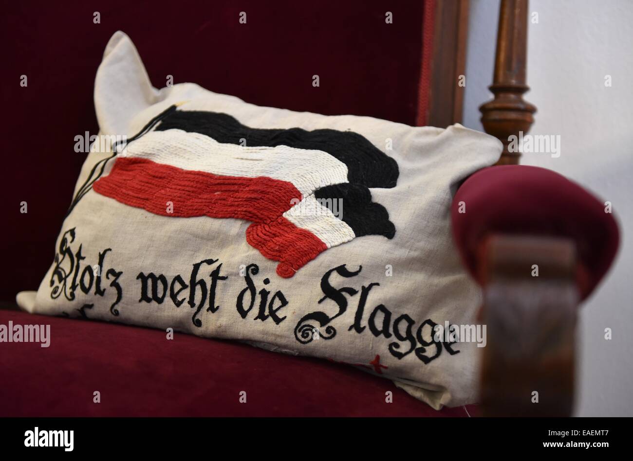 'Proud like the Flag' is embroidered onto a cushion with the German flag in the Museum for Sepulchral Culture in Kassel, Germany, 13 November 2014. It is part of the exhibition 'Die Verwandlung. Sterben und Trauer 1914 bis 1918' (Metamorphosis. Death and Mourning 1914 to 1918) which opens on 14 November. Photo: UWE ZUCCHI/dpa Stock Photo