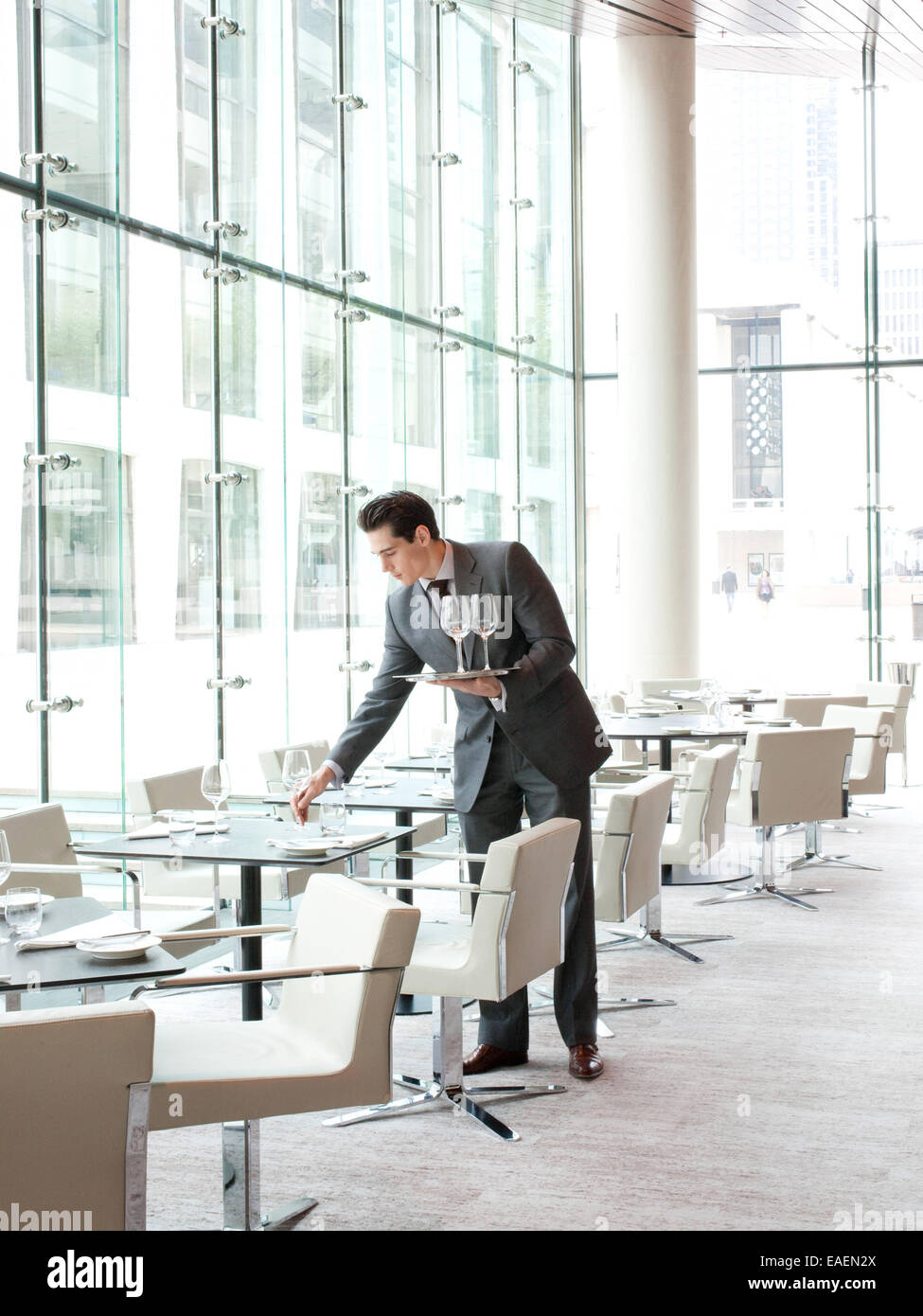 waiter setting table in upscale restaurant Stock Photo