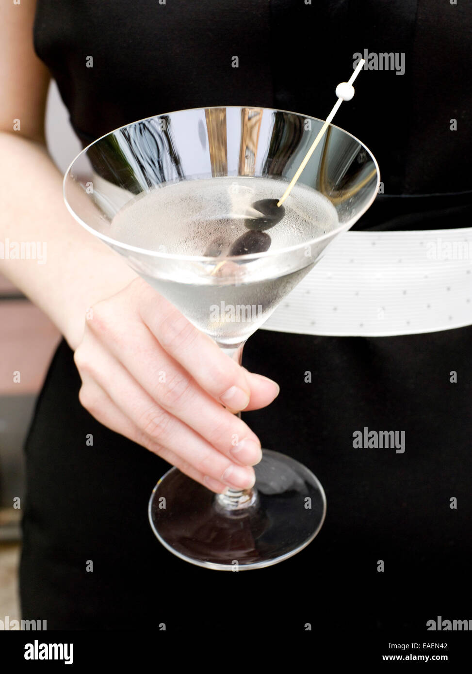 formally dressed woman holding a martini Stock Photo
