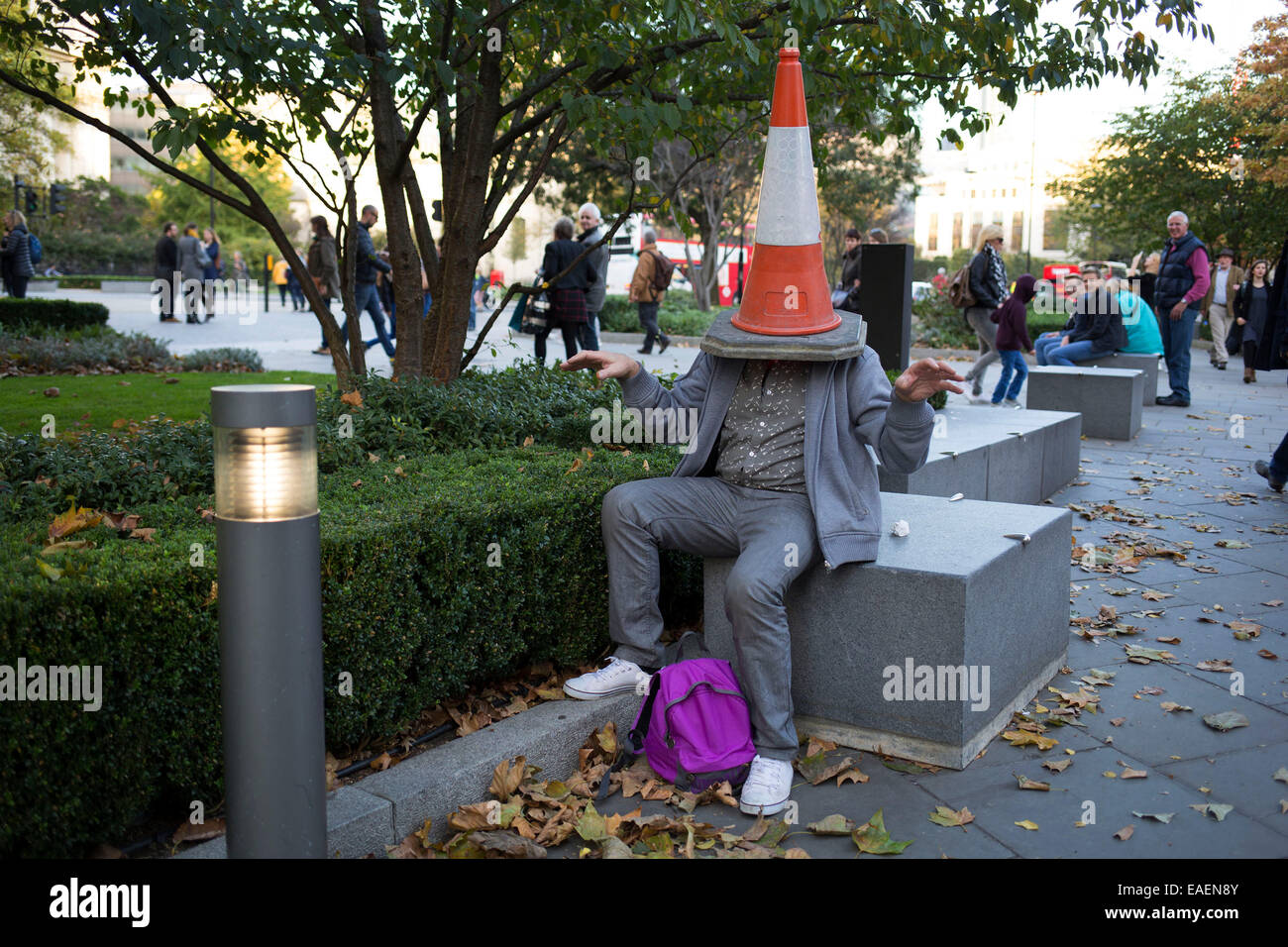 Man larking around with a traffic cone on his head. A visitor from out