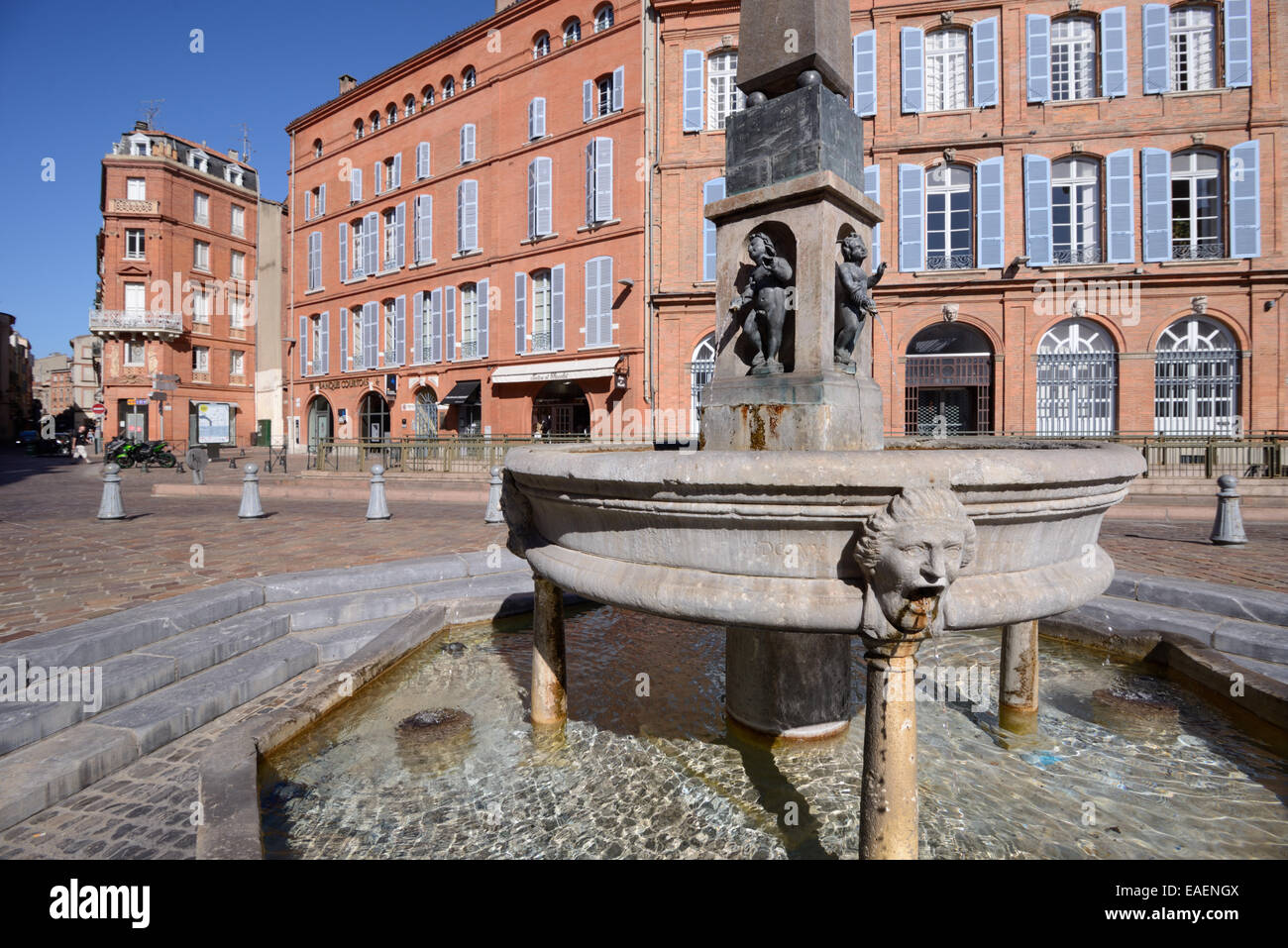Street Fountain and Red Brick Architecture on Place Etienne or Town Square Toulouse Haute-Garonne France Stock Photo
