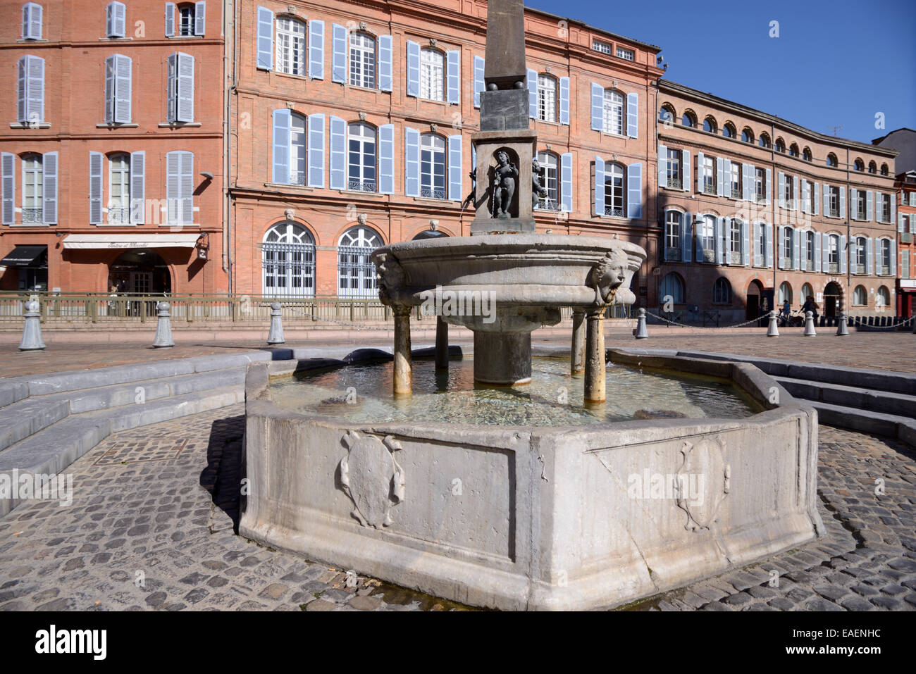 Street Fountain in Place Etienne and Red Brick Facades of Terraced Townhouses Toulouse France Stock Photo