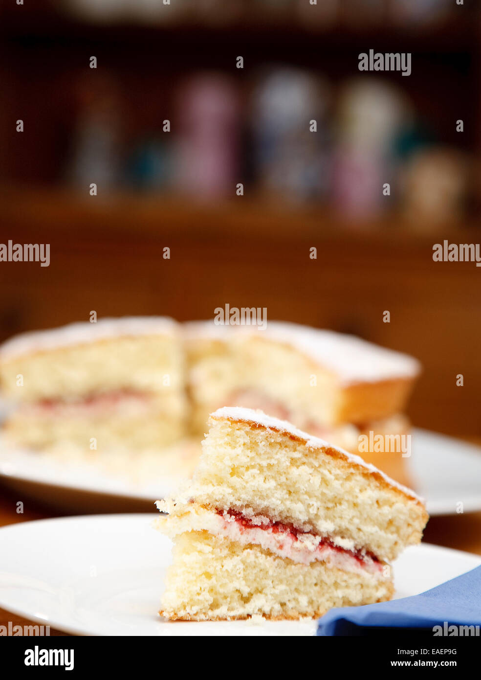 traditional victoria sponge cake with buttercream and jam filling in a