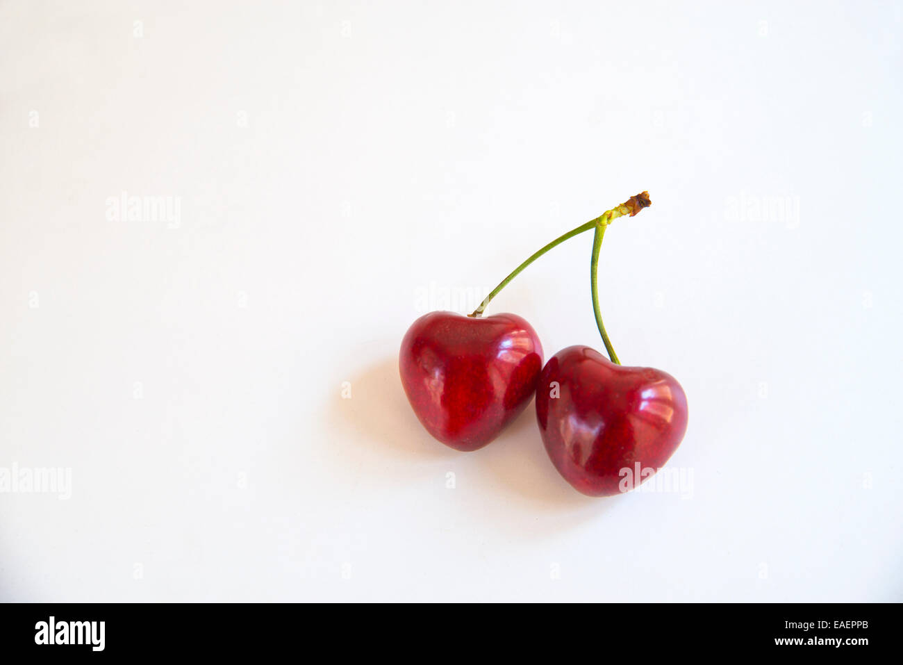 Two heart-shaped cherries. Stock Photo