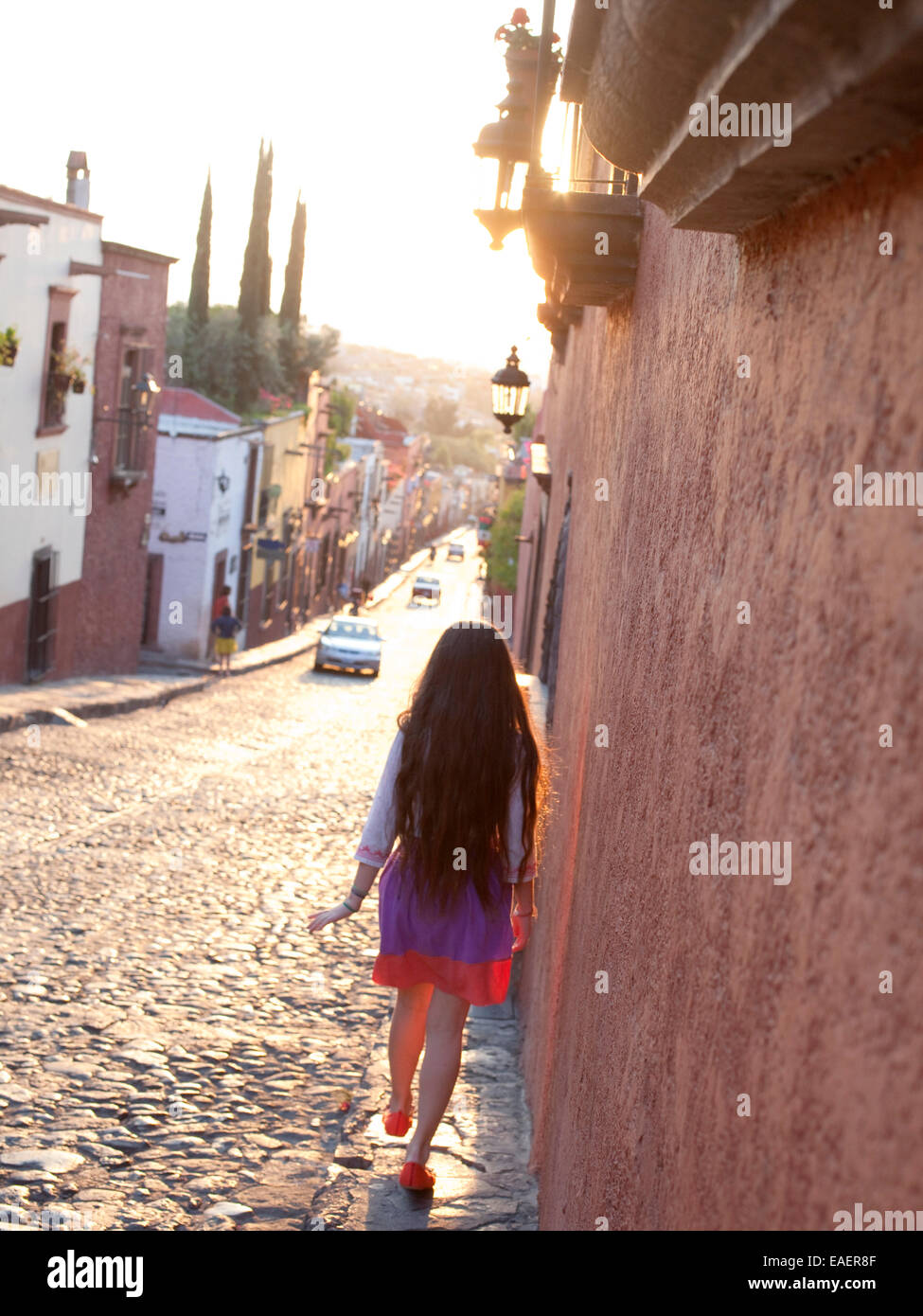 young girl walks sidewalk of Mexican Village Stock Photo