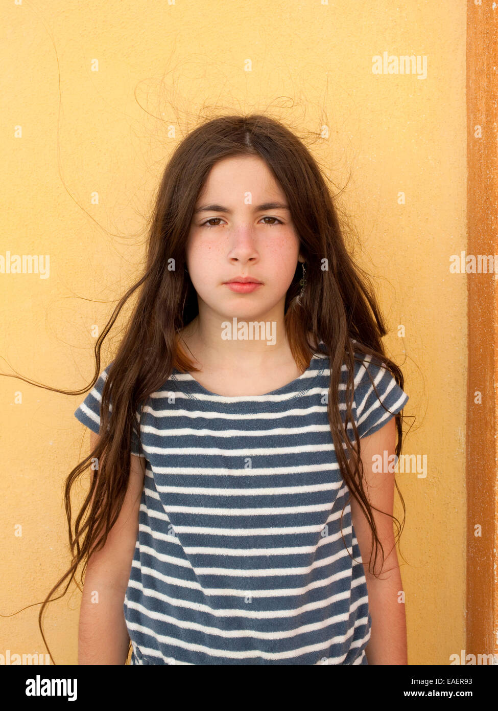 Young Girl with serious expression and frizzy hair Stock Photo