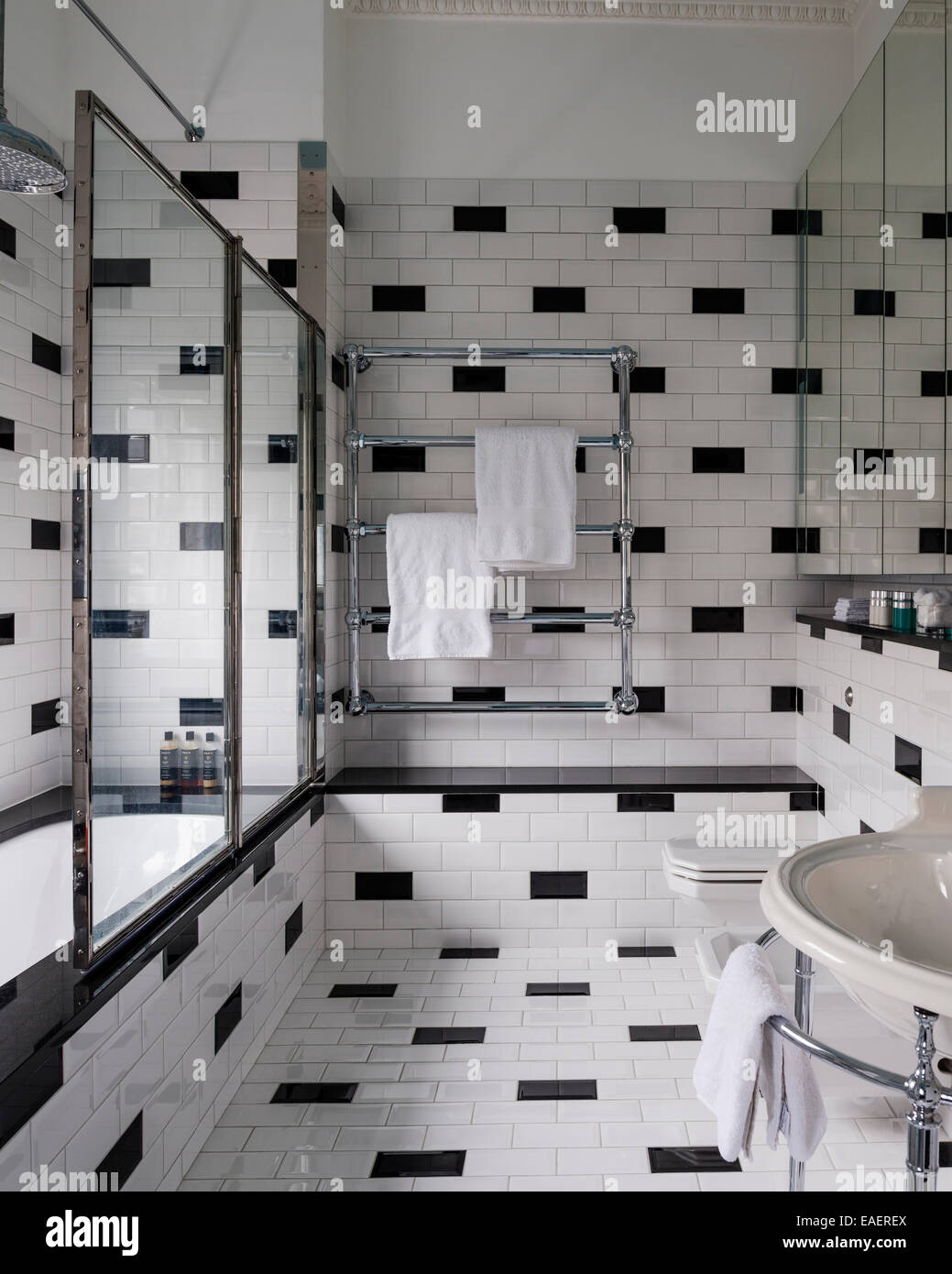 1940's style bathroom from Drummonds with black and white brick formation tile work Stock Photo