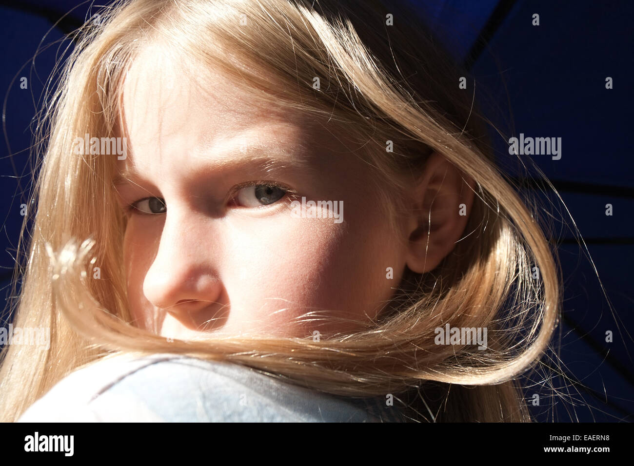girl face with closeup of grey eyes look Stock Photo