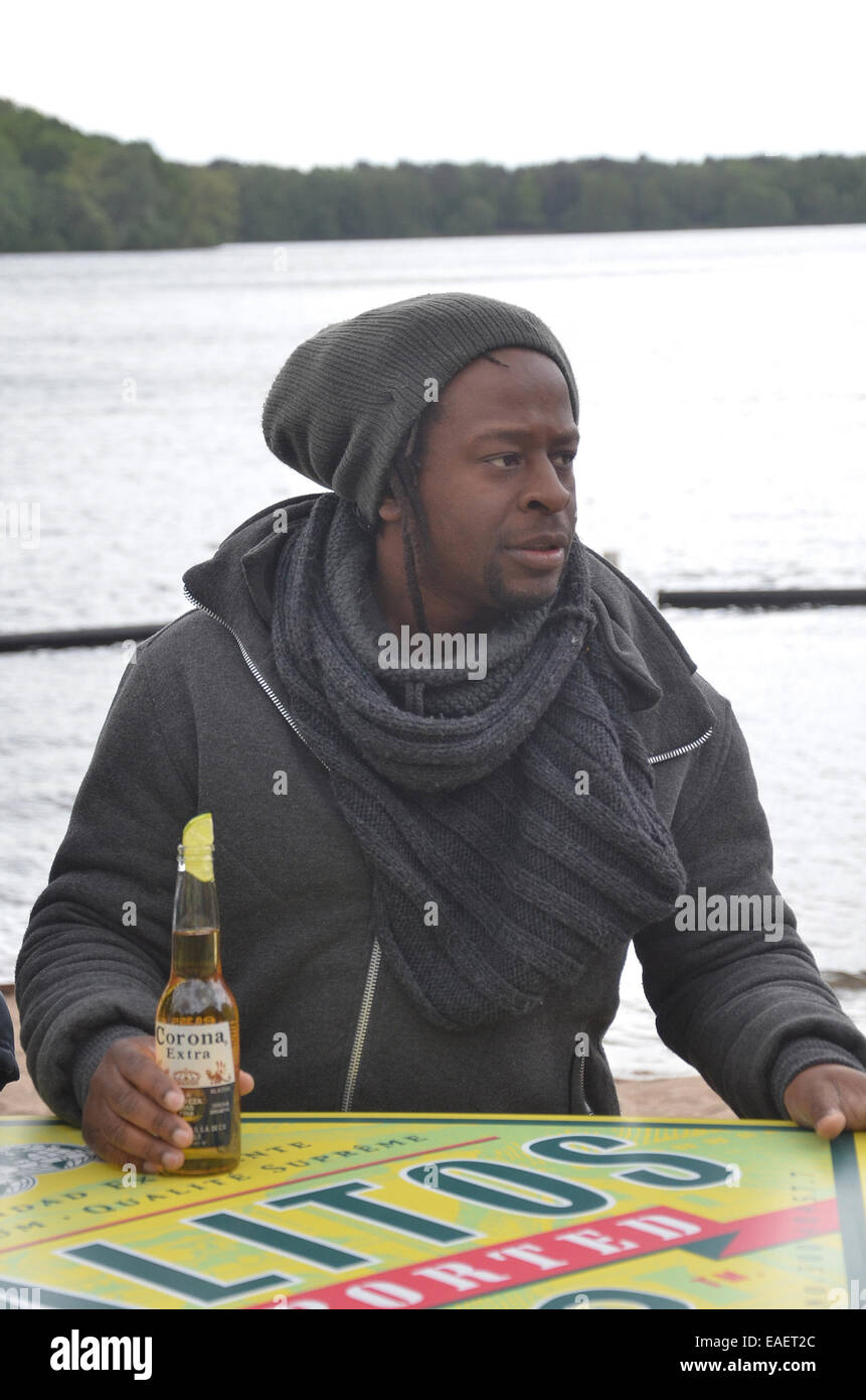 Mola Adebisi opens his own beach bar at Freibad Wolfssee with special guest Melanie Mueller  Featuring: Mola Adebisi Where: Duisburg, Germany When: 11 May 2014 Stock Photo
