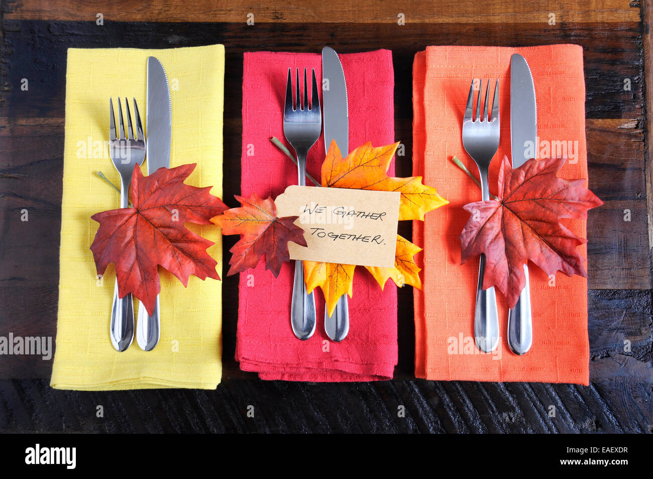 Happy Thanksgiving table place setting with We Gather Together place card and autumn fall leaf decorations Stock Photo