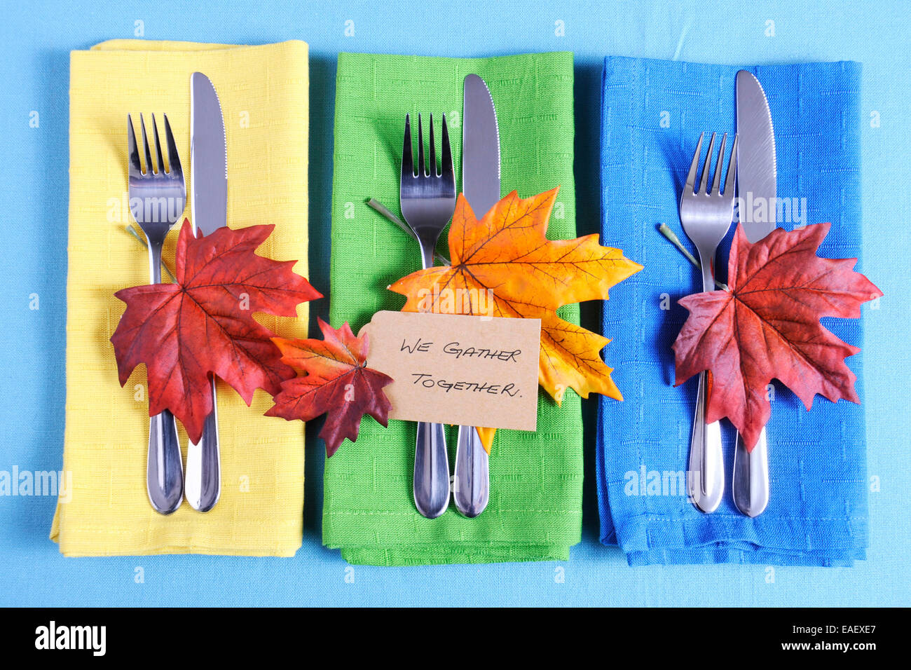 Happy Thanksgiving table place setting with We Gather Together place card and autumn fall leaf decorations Stock Photo