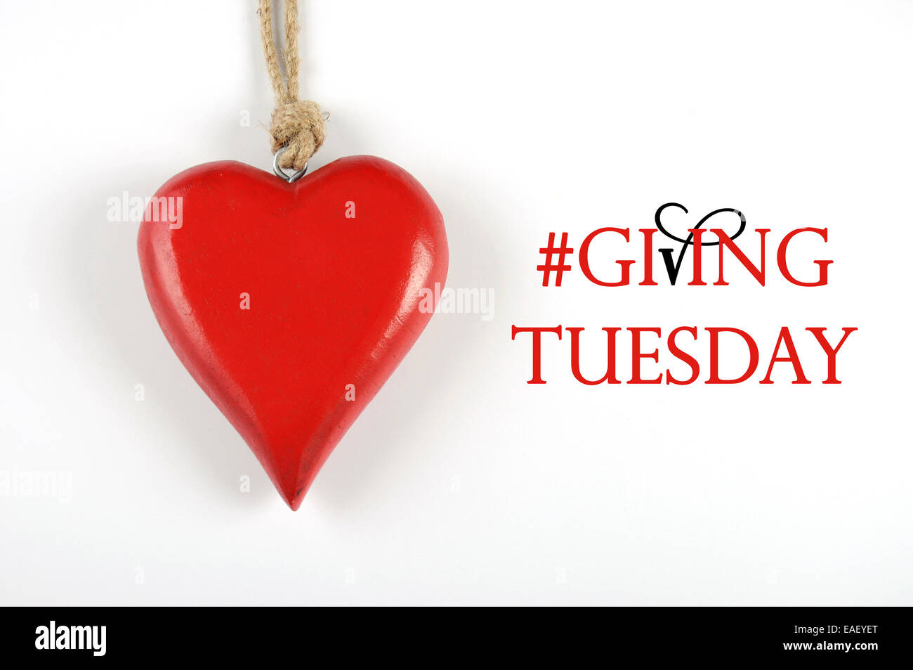 Giving Tuesday philanthropy day after Black Friday shopping message sign with red heart and sample text. Stock Photo